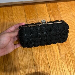 Flowered black Bebe clutch